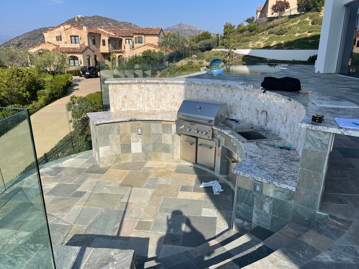 Finished outdoor kitchen and seating area by Panjia Outdoors in Poway