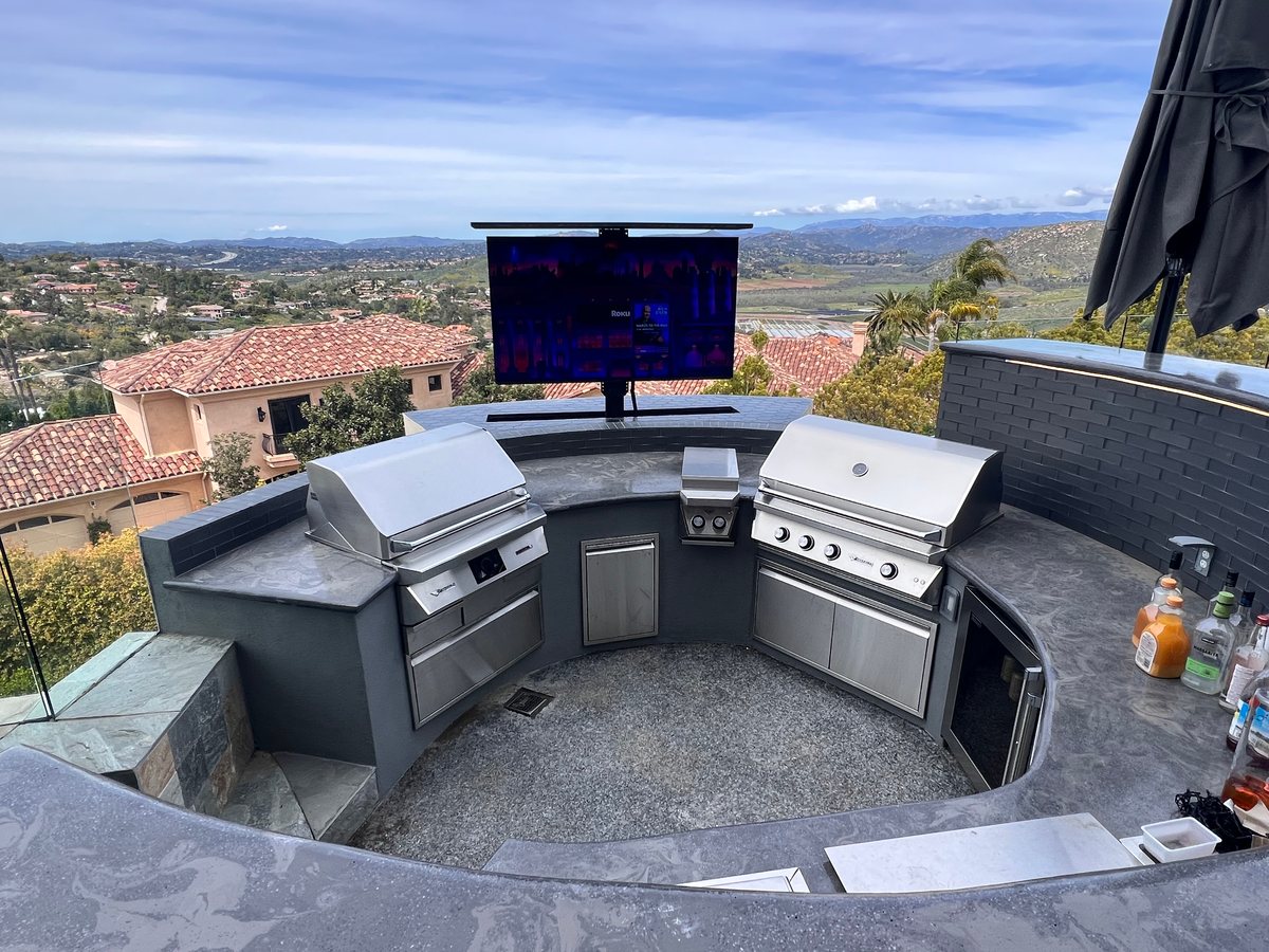 Custom outdoor kitchen with built-in grills and panoramic view by Panjia Outdoors in Poway