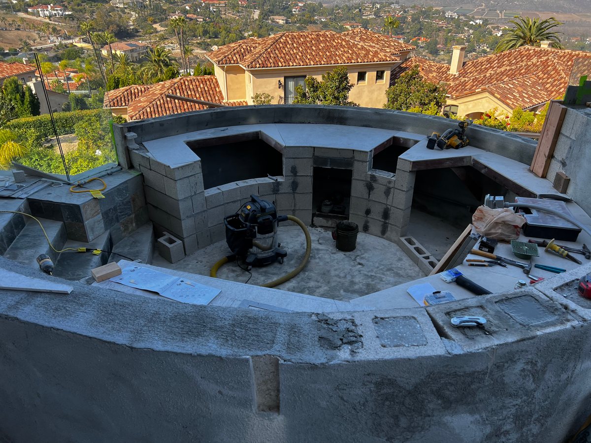 Stone-faced outdoor kitchen with hillside view in Poway by Panjia Outdoors
