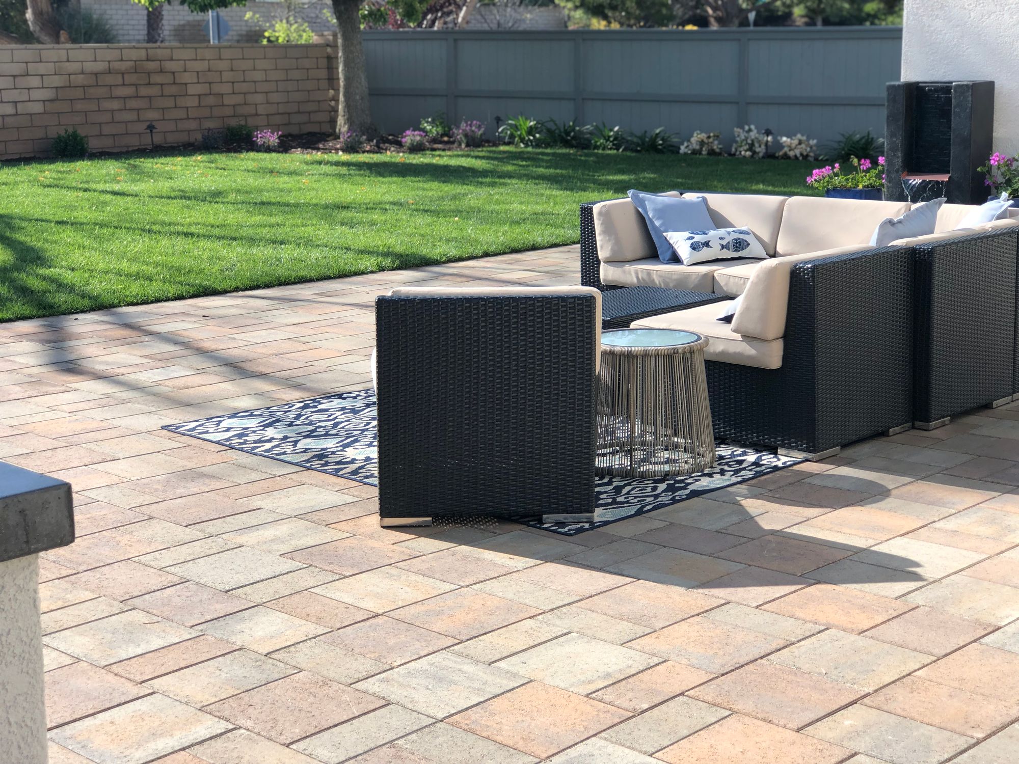 Paver patio with seating area and lawn in North County San Diego by Panjia Outdoors